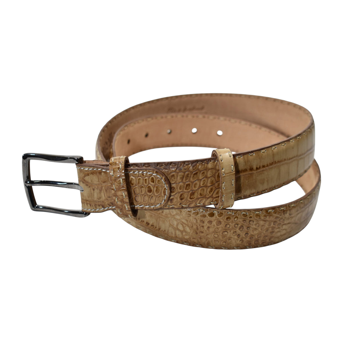 A Marcello tan leather belt with a crocodile-embossed texture and a silver-tone metal buckle, coiled on a plain white background.