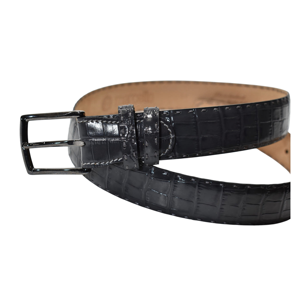 A Marcello charcoal crocodile-embossed leather belt with a silver-tone metal buckle, coiled on a solid white background.