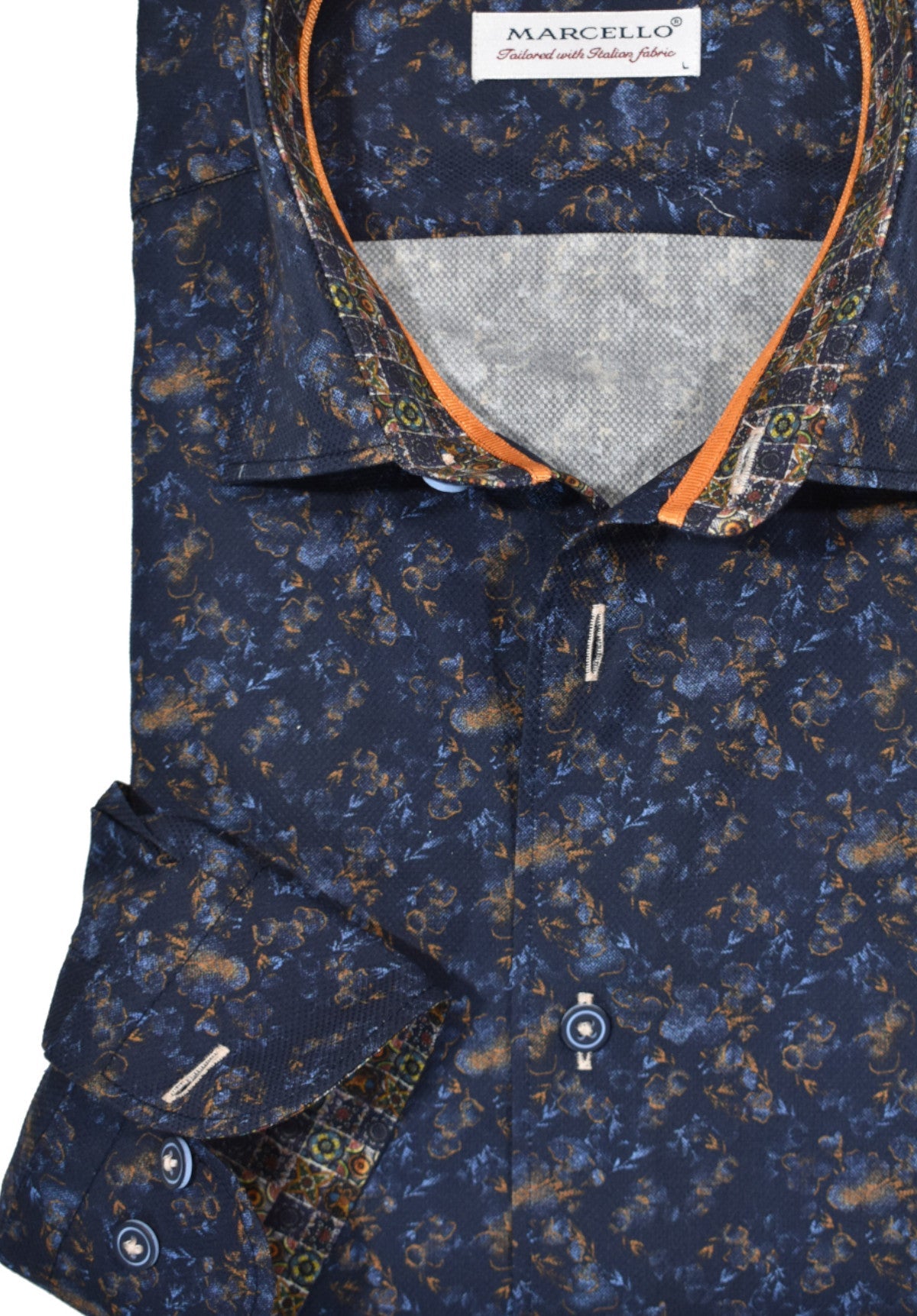 A great way to elevate your wardrobe with effortless style. Featuring a navy cotton fabric with an elegant abstract print, the W730 Whisp Abstract Print looks amazing tucked or untucked, perfectly complemented by slim trim fabric, a striking orange neck trim and well-matched buttons. Enjoy a classic shaped fit. by Marcello
