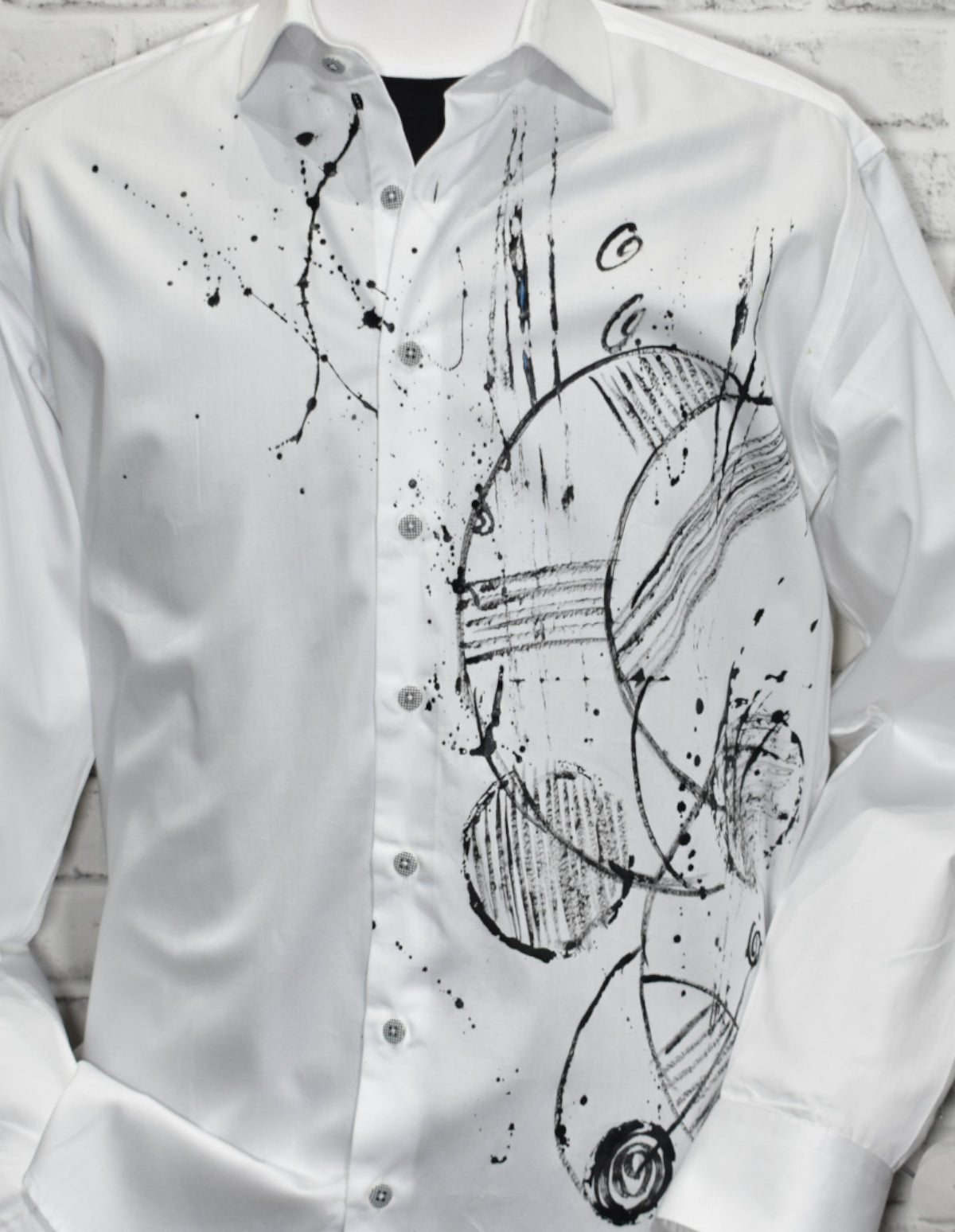 Experience luxe style with the Shades of Black Hand Painted shirt! Crafted with rich white cotton sateen fabric and featuring a custom hand painted abstract geometric pattern, this shirt stands out from the rest. With a classic shaped fit for a timeless look, this unique design is an exclusive to Marcello.