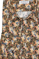 Elevate your wardrobe with this W796 Sun's Clay Sport Shirt. Perfect for any occasion, its rich colors and earth tones are offset by subtle blue floral accents, and double track contrast stitching adds a stylish touch. Thoughtfully crafted with hand-selected buttons and an accent neck placket taping, you'll be looking your best. Shirt by Marcello.