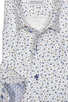 This soft herringbone shirt boasts a subtle micro floral pattern in navy and camel, making it a stylish addition to any wardrobe. Shirt by Marcello.