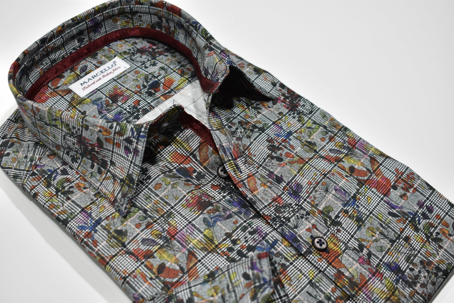 Upgrade your fall wardrobe with the Marcello Autumn Plaid shirt. Its soft gray ground and charcoal-black plaid pattern add a touch of sophistication, while the Autumn leaves overprint adds a pop of color. Perfect for pairing with charcoal or black pants or jeans, this shirt is a versatile and stylish choice for the season.