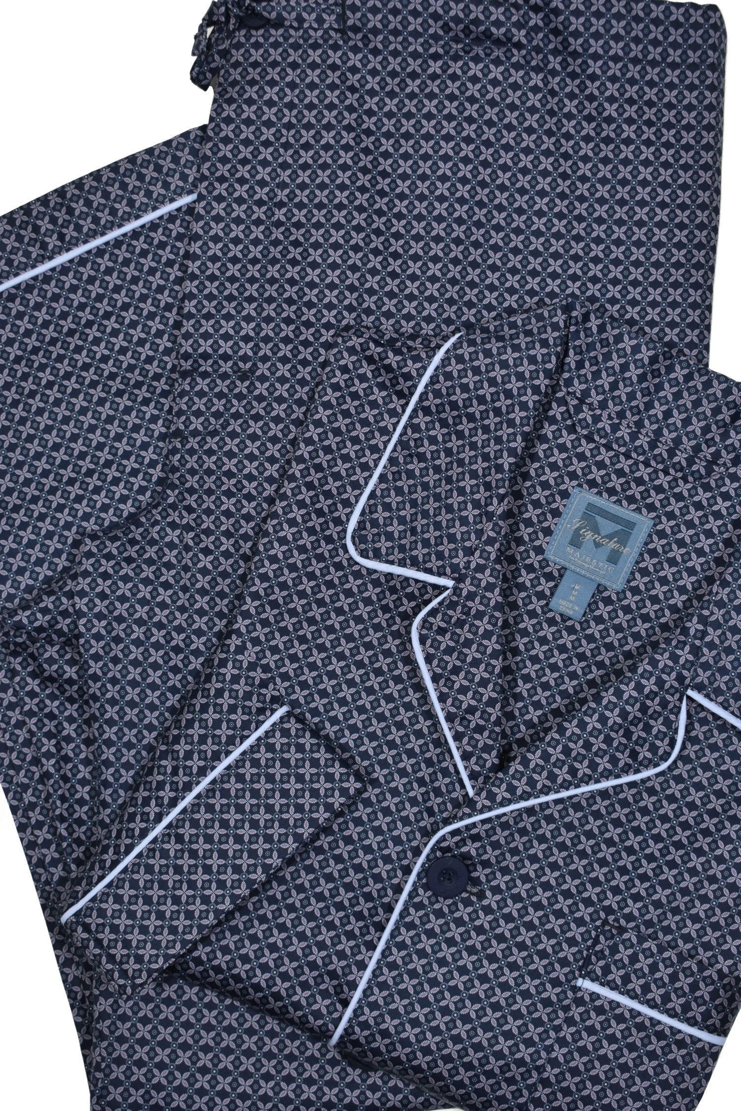 Feel cozy and relaxed in this classic navy flora pajama set. Crafted in soft cotton, this pajama is designed with a coat top with chest pocket and draw string bottoms with stretch waist for optimal comfort. Experience a luxurious night's sleep with the perfect combination of style and comfort.