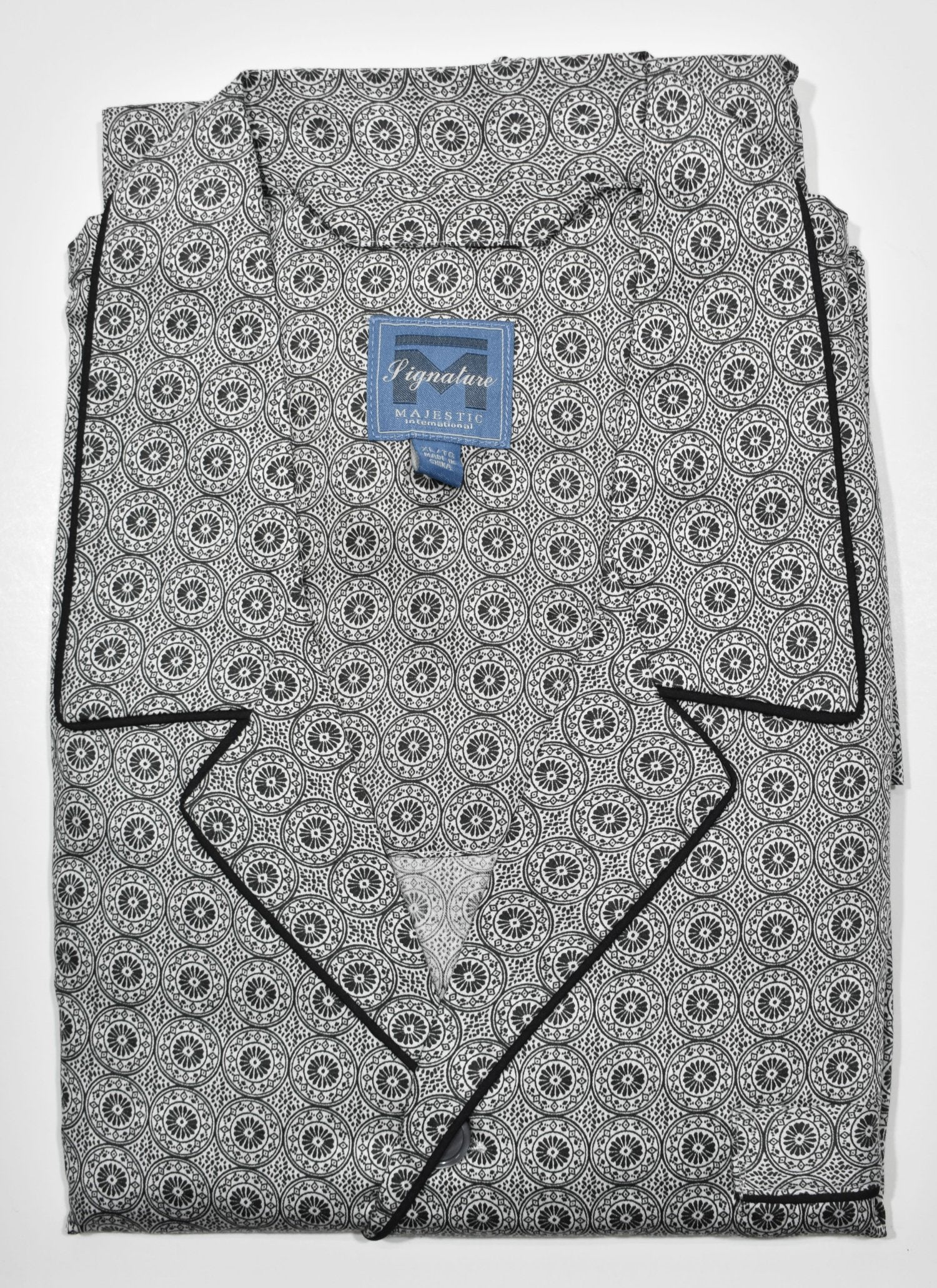 Indulge in luxurious comfort with the ZMJ9190 Slate Medallion Pajama. Made with soft cotton and featuring a circular medallion pattern, this classic pajama set offers a relaxed fit and added style with contrast black piping and a drawstring waist. The perfect choice for a good night's sleep.