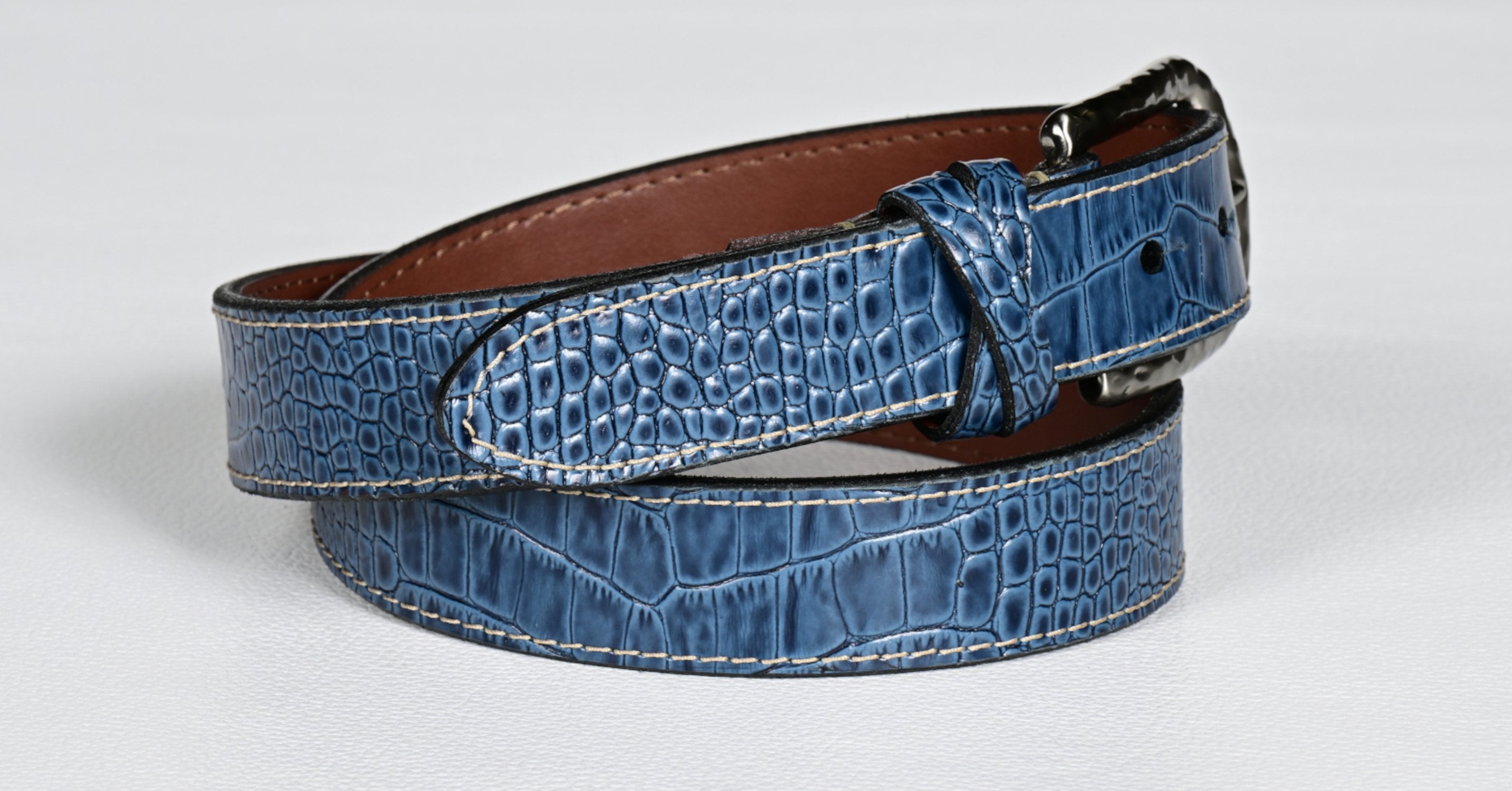 Elevate your style with our luxurious Italian gator embossed calfskin belt in sharp indigo.