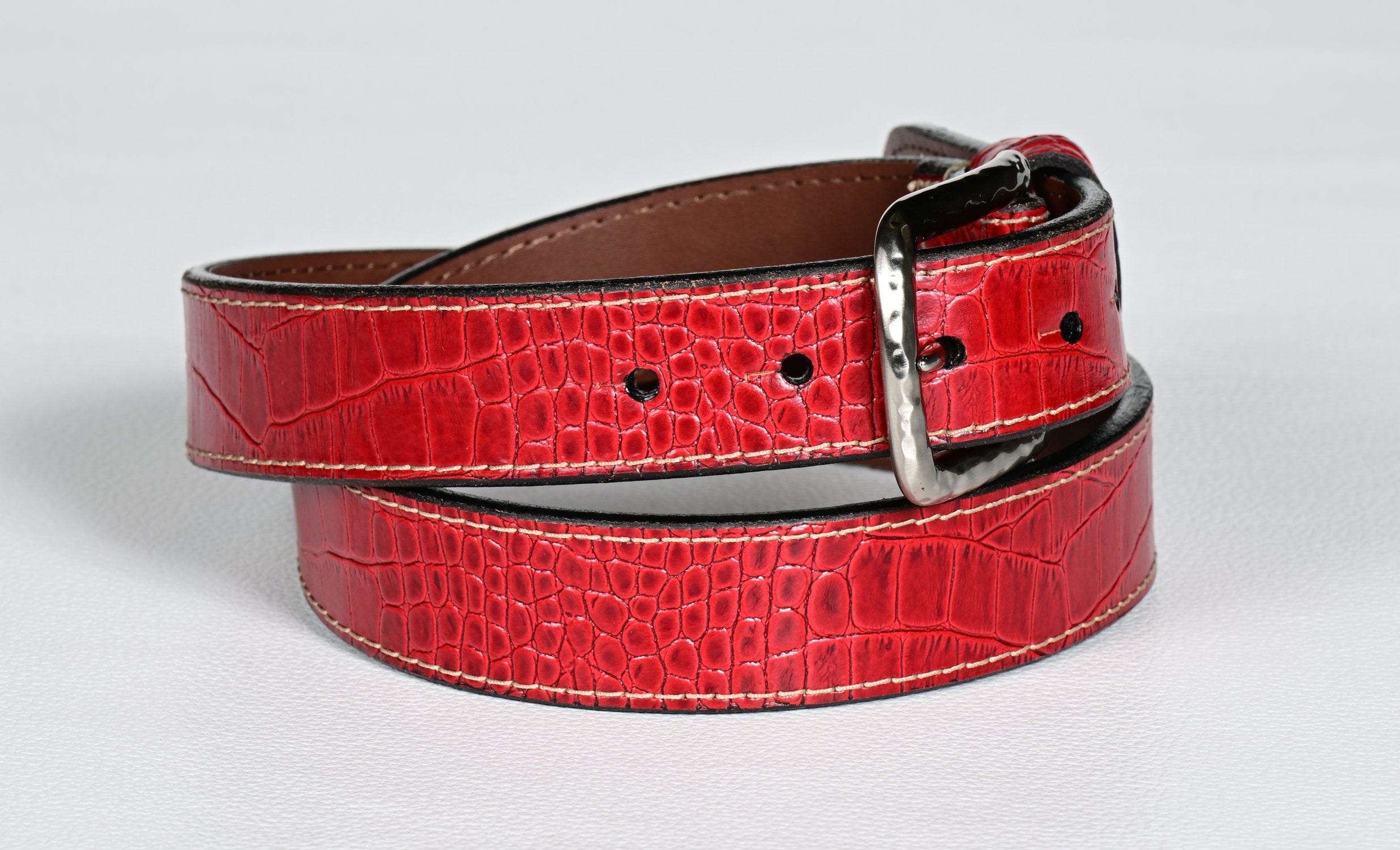 Elevate your style with our luxurious Italian gator embossed calfskin belt in distinctive red. Offered by Marcello.