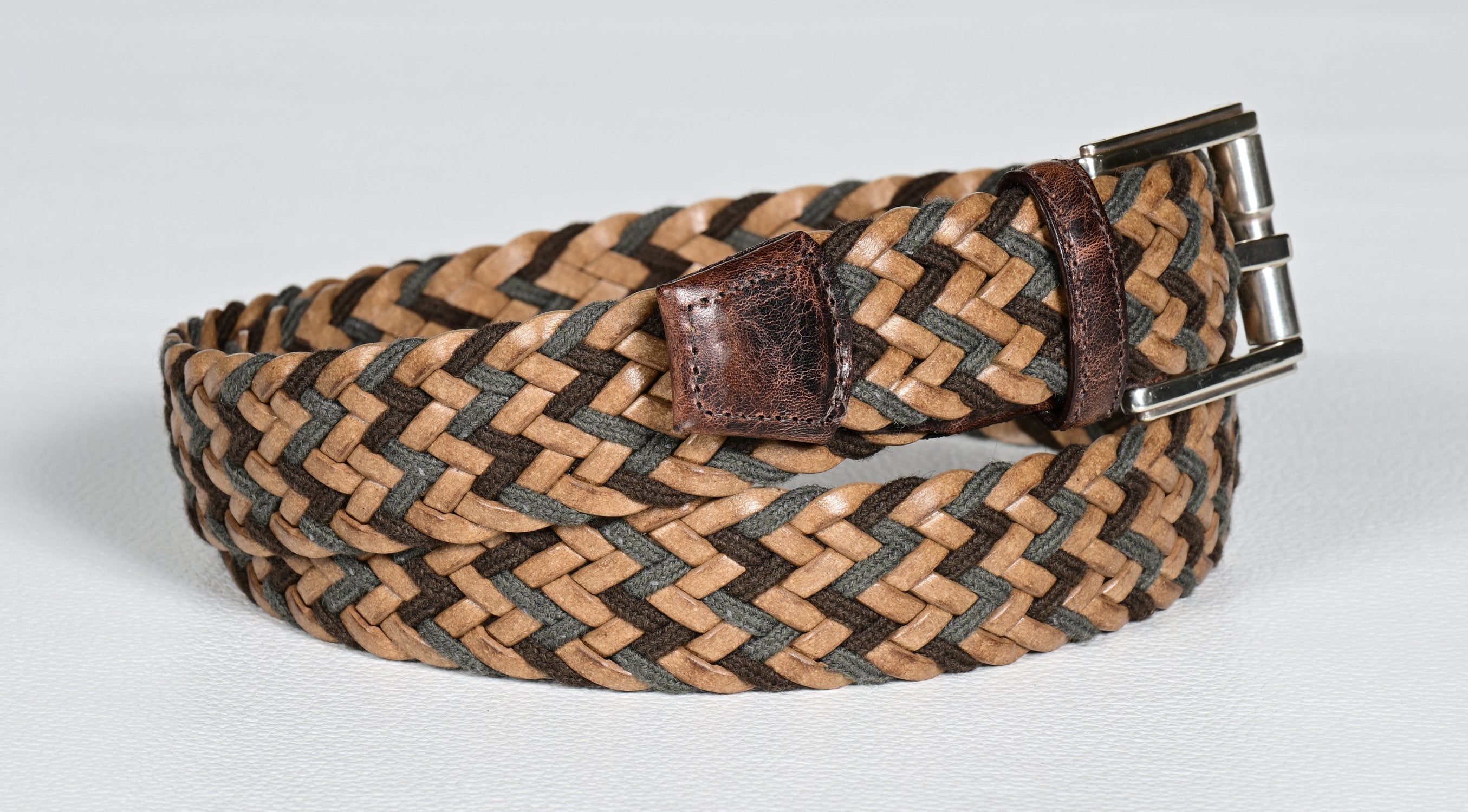 Elevate your style with our Tan-Chocolate Chevron Weave belt. Belt offered by Marcello.