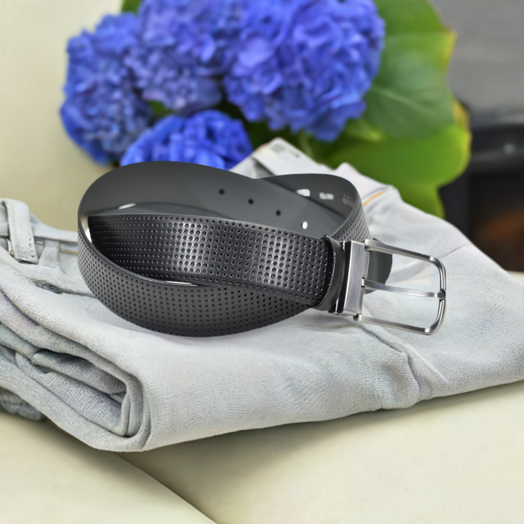 This sophisticated perforation detail is crafted with extra fine leather, offering a classic and up-to-date look. Choose between black or chocolate options, and complete the look with a satin nickel finished buckle. Slightly wider than average, this premium belt will pair perfectly with your favorite jeans or pants for a contemporary image.