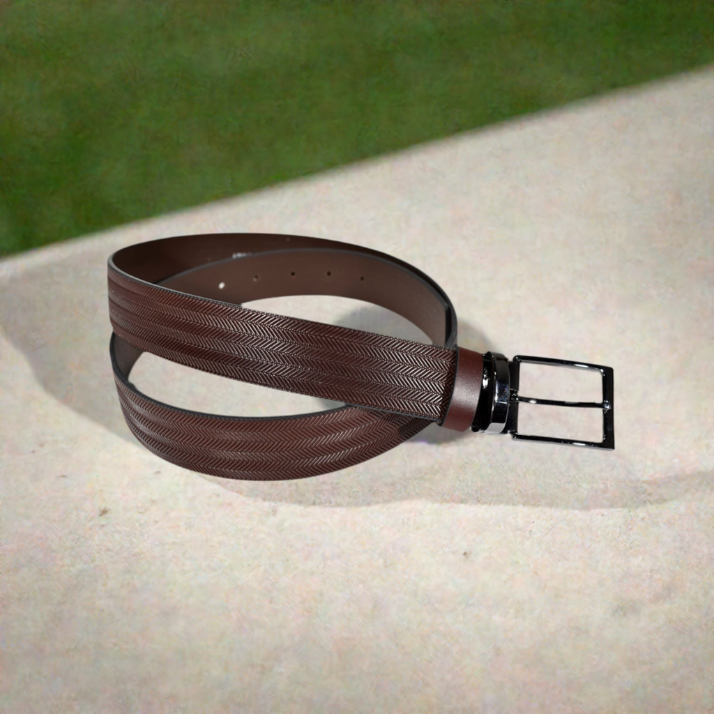 A luxurious and sophisticated herringbone pattern is elevated on luxurious, supple leather, creating a timeless style. Showcased with a brushed nickel buckle, this is truly a unique piece.