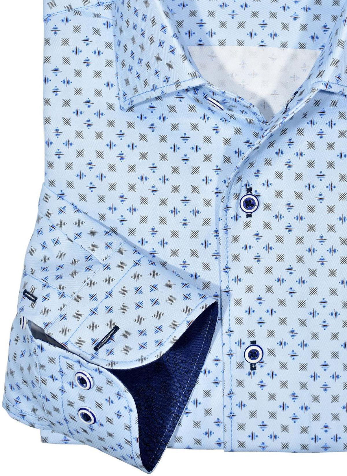 Our exclusive 1 piece roll collar is like no other. The way it stands perfect and rolls for a smooth updated image is perfect. Accentuate your slim style with this updated traditional pattern in a fresh sky coloration with mocha and navy accents. Soft cotton fabric. Fashion contrast stitching. Custom selected buttons. Two button sleeve system for perfect cuff rollups. Slim fit. Shirt by Marcello Sport.