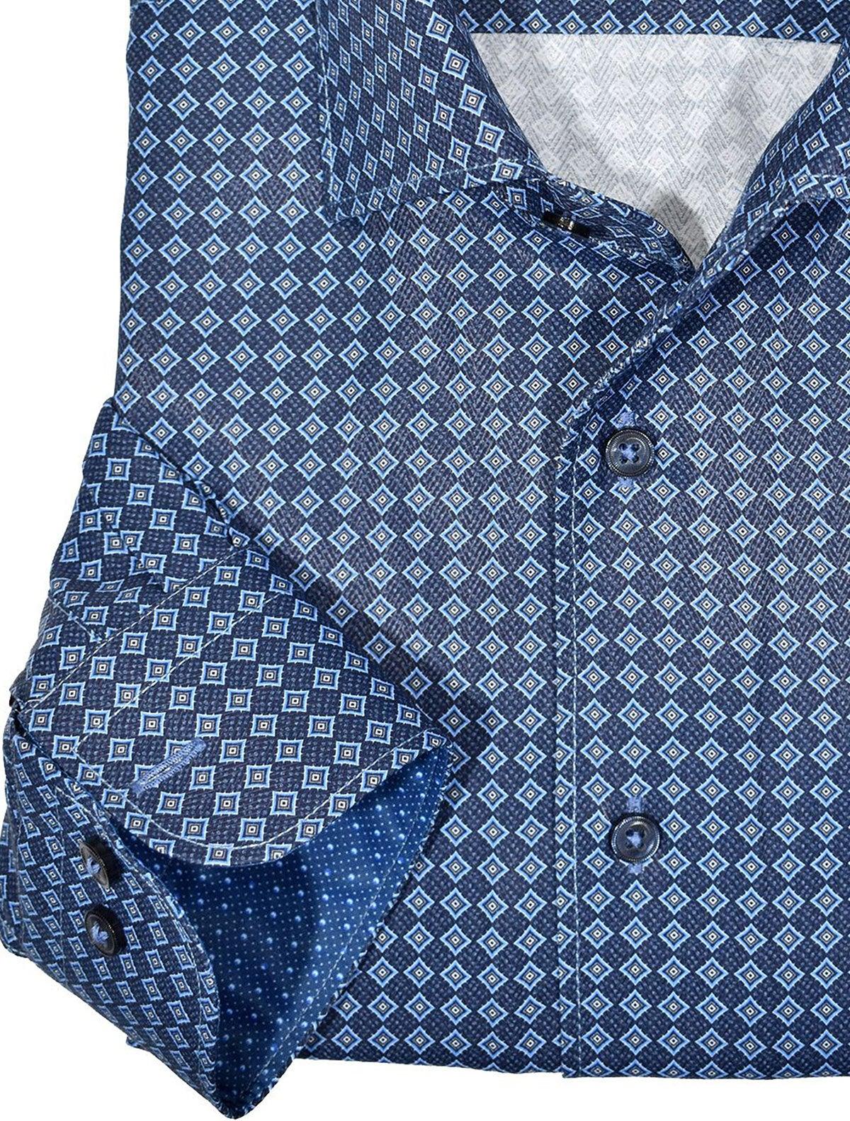 Marcello exclusive 1 piece roll collar shirt is the ultimate in style and sophistication. The one piece collar stands perfectly and looks great alone or under a sport coat. You will surely want every one piece roll collar shirt we offer. Rich cotton / microfiber fabric. Fashion diamond medallion pattern in rich blue colors. Adjustable 2 button cuffs. Unique extra sleeve button to roll cuffs without flaring. Slim fit. Shirt by Marcello Sport