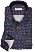Exclusive Marcello 1 Piece Roll Collar Shirt.  The one piece roll collar stands perfectly and looks fantastic alone or under a sport coat.  The multi navy paisley pattern coupled with a rich fabric creates a sophisticated look to set your apart from the rest.  Hand selected buttons, two button cuff placket for the best look when rolling up the cuffs and enhanced stitch detailing.  Classic shaped fit.