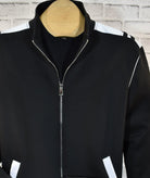 Poly microfiber fabric for comfort and style. Accent white trim on shoulders, armholes and pockets. Classic jacket style with side slash pockets and full zip, great for layering. Pant features a stretch waist band, tie front and classic pockets. Pants feature an open bottom. Made in Italy.