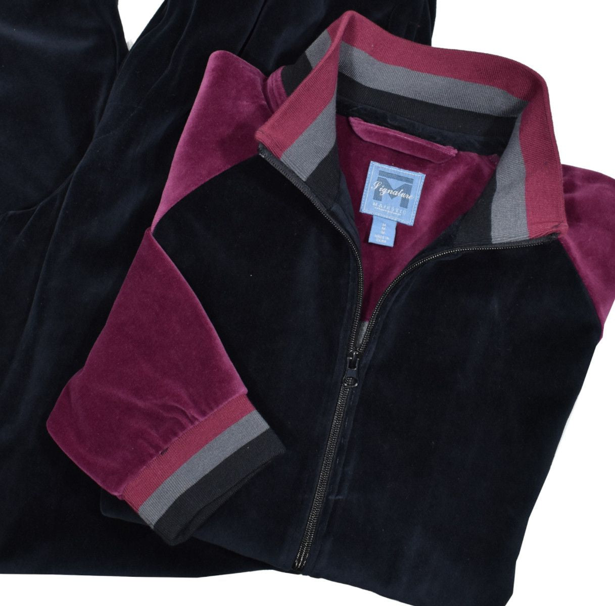 Fashion style in a velour microfiber fabric featuring a black top with wine accent color down the shoulders and sleeves, with a knitted collar, cuff and waist band matching the body colors. Cool leisure set model with a dressy super soft feel. The top features classic side slash pockets. Classic draw string pant with stretch waist band, and regular pocket detailing. Classic fit.