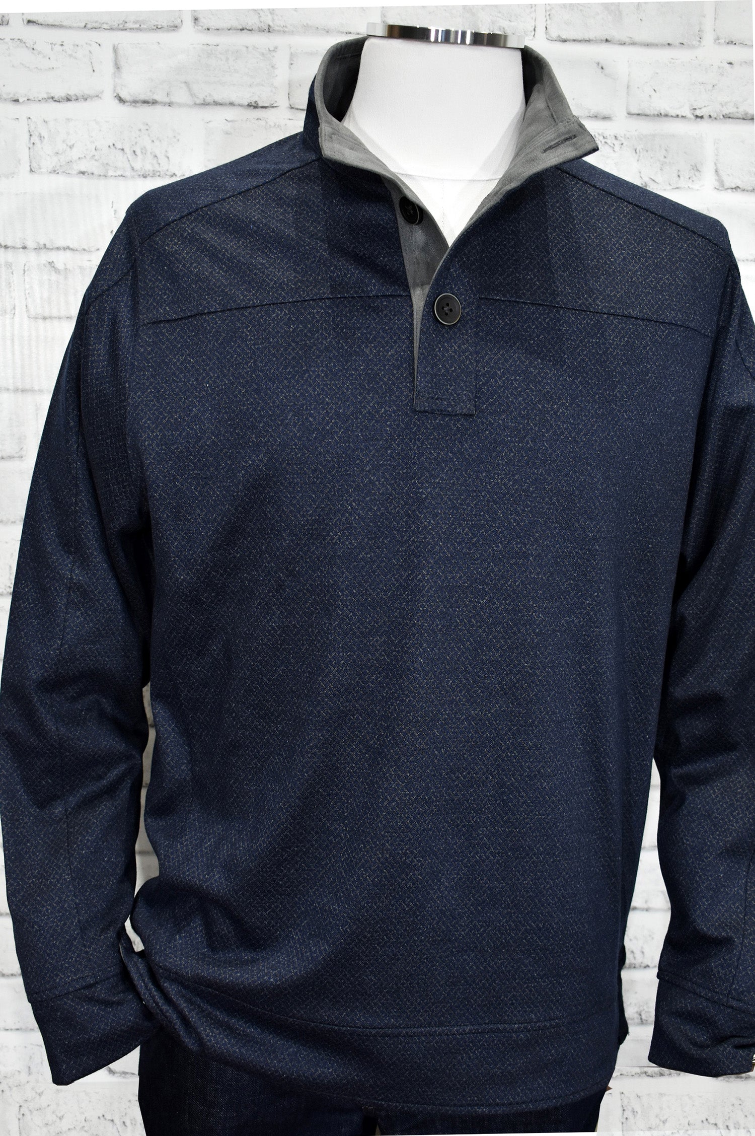 A classic mock neck in cotton microfiber fabric with a fine diamond pattern in soft gray over a navy ground. The performance fabric is great for any event and traveling. Add style to this basic mock with suede trim in the neck and along the button placket. Open sleeves and open bottom for a cool contemporary style. Light weight. Classic fit.