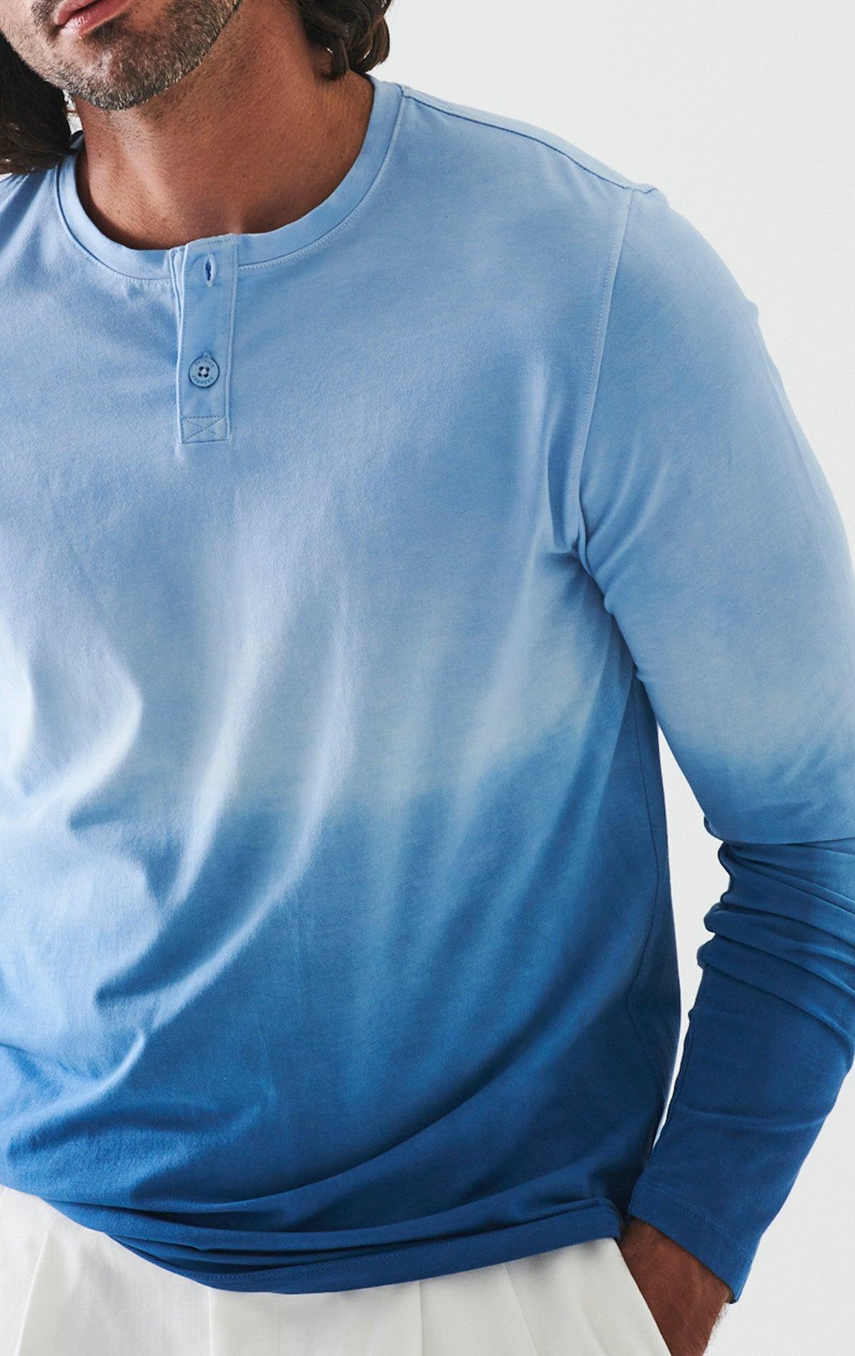 The ultimate in comfort and softness, this long sleeve cotton henly model sports a fine contemporary style.  The soft blue combined with darker blues are washed for a soft, cool look. Soft pima cotton. Designed by Assaraf Italy. Button closure henly type collar. Open sleeves and bottom. Modern fit, perfect for a slim to medium build.