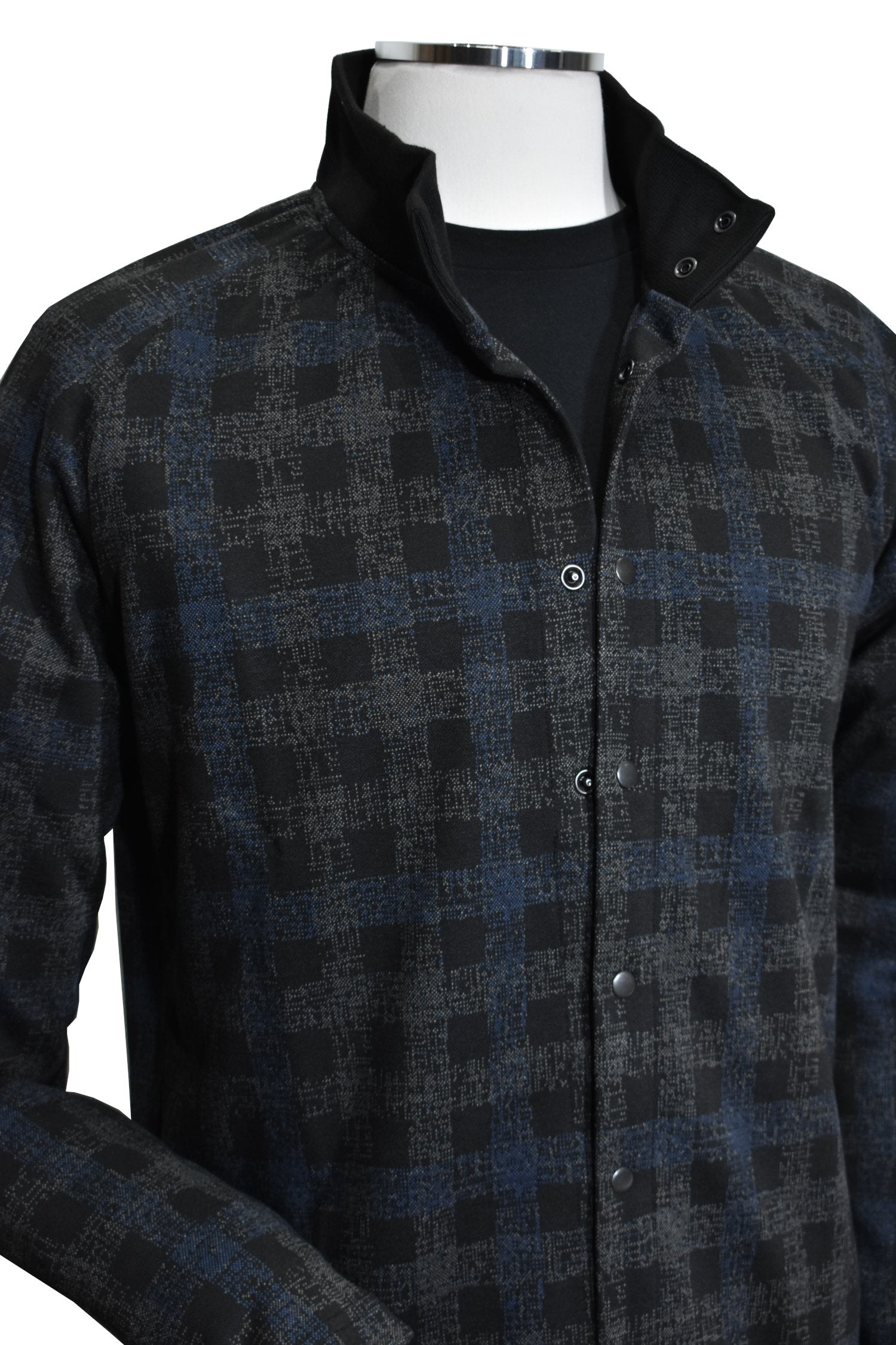 Introducing the Marcello Terrio Button Front Shacket, the perfect combination of style and functionality. This shirt jacket features a classic mock collar and snap enclosure, along with open sleeve cuffs and a waist band for a comfortable fit. The rich black base color is accented with a charcoal plaid pattern and a pop of royal blue.