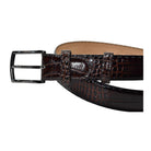 A Marcello dark brown crocodile-embossed leather belt with a black metal buckle, coiled on a plain white background.