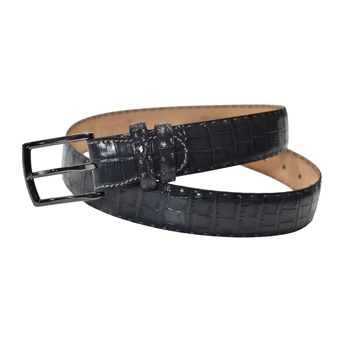 A Marcello charcoal crocodile-embossed leather belt with a silver-tone metal buckle, coiled on a solid white background.