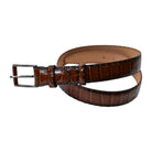 A Marcello Mocha Brown crocodile-embossed leather belt with a silver-tone metal buckle, coiled on a plain white background.