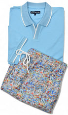Light blue polo shirt and floral shorts set on a white background by Marcello