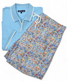 Light blue polo shirt and floral shorts on a white background by Marcello