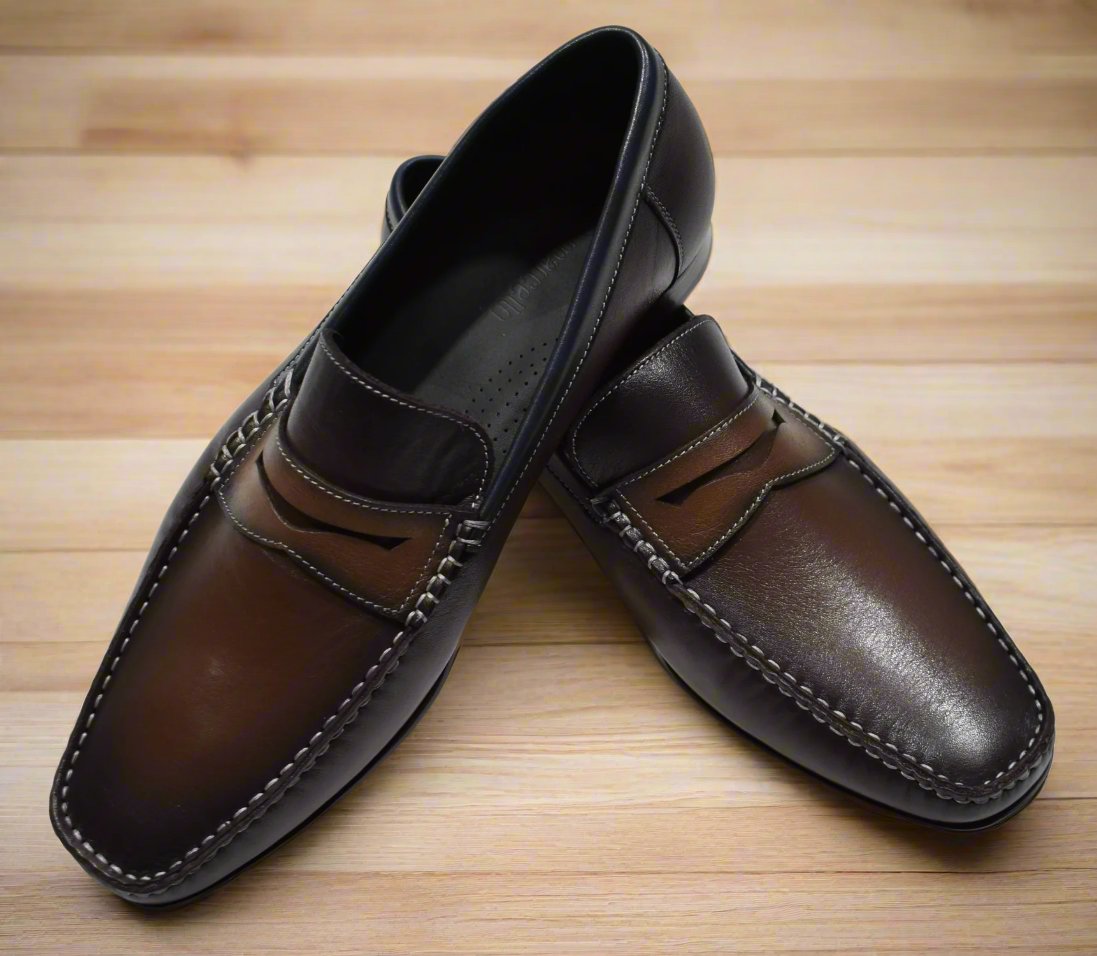 Marcello S127 Chocolate Dress Sport Shoe brings a touch of modern sophistication to any look. The burnished leather shoe in rich chocolate with tan accents is perfect for formal and casual wear, providing a timeless style with a hint of flair. Handcrafted in Spain and designed with a classic fit, this shoe is sure to become a wardrobe staple.