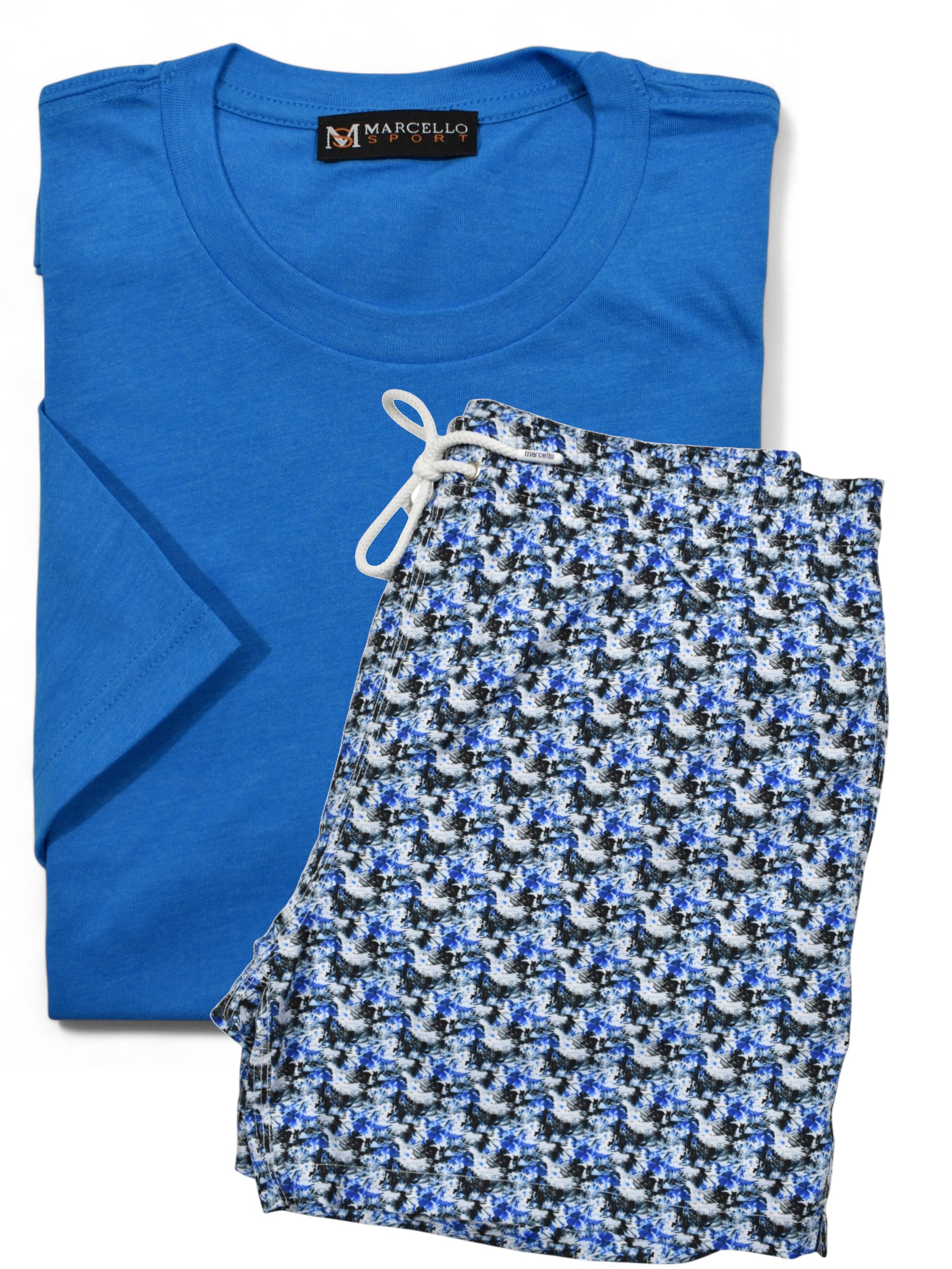 Marcello folded blue t-shirt and floral swim short with a visible brand label on a white background