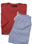 Marcello folded red t-shirt and blue patterned swim shorts with a visible brand label on a white background