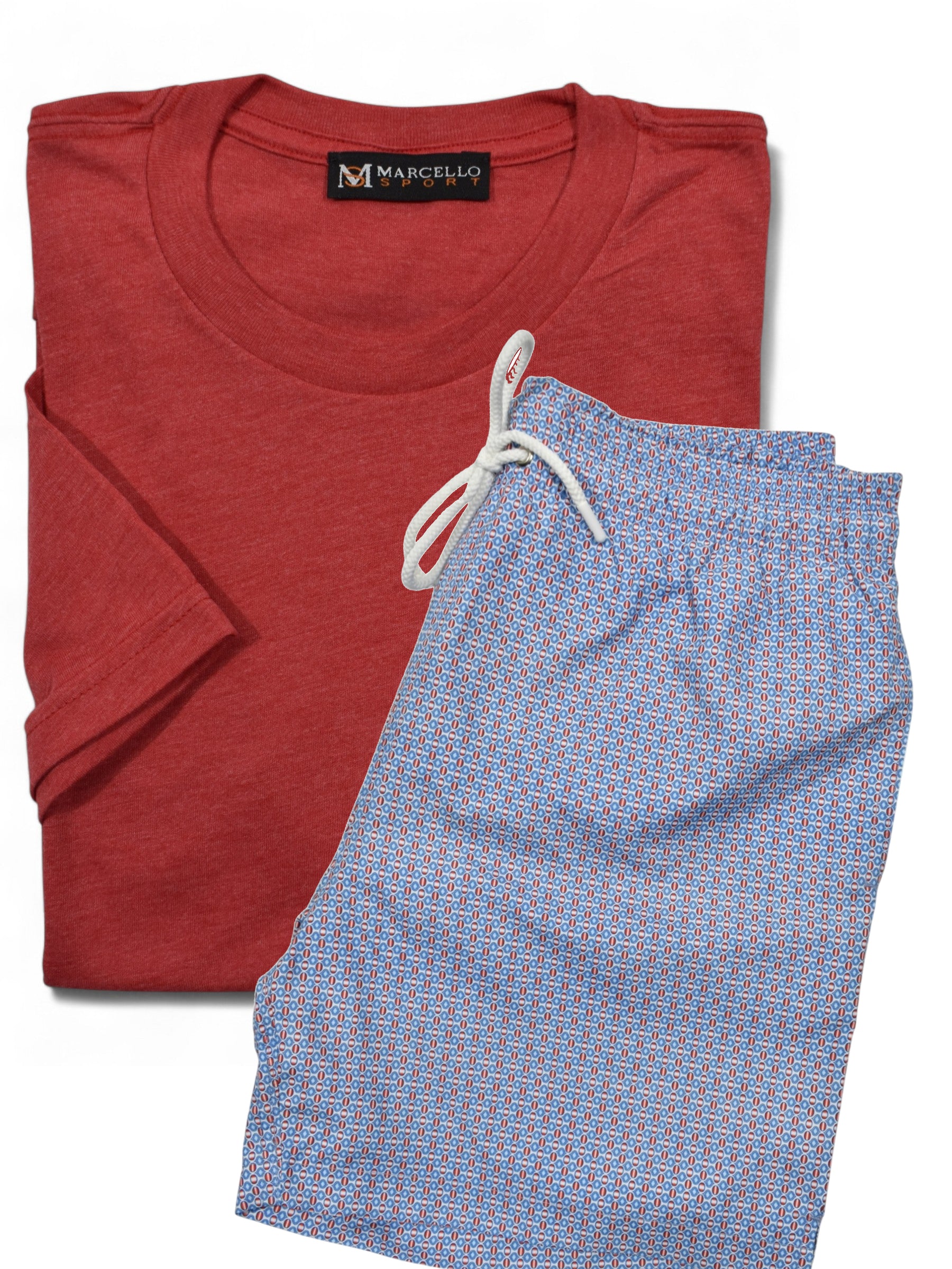 Marcello folded red t-shirt and blue patterned swim shorts with a visible brand label on a white background