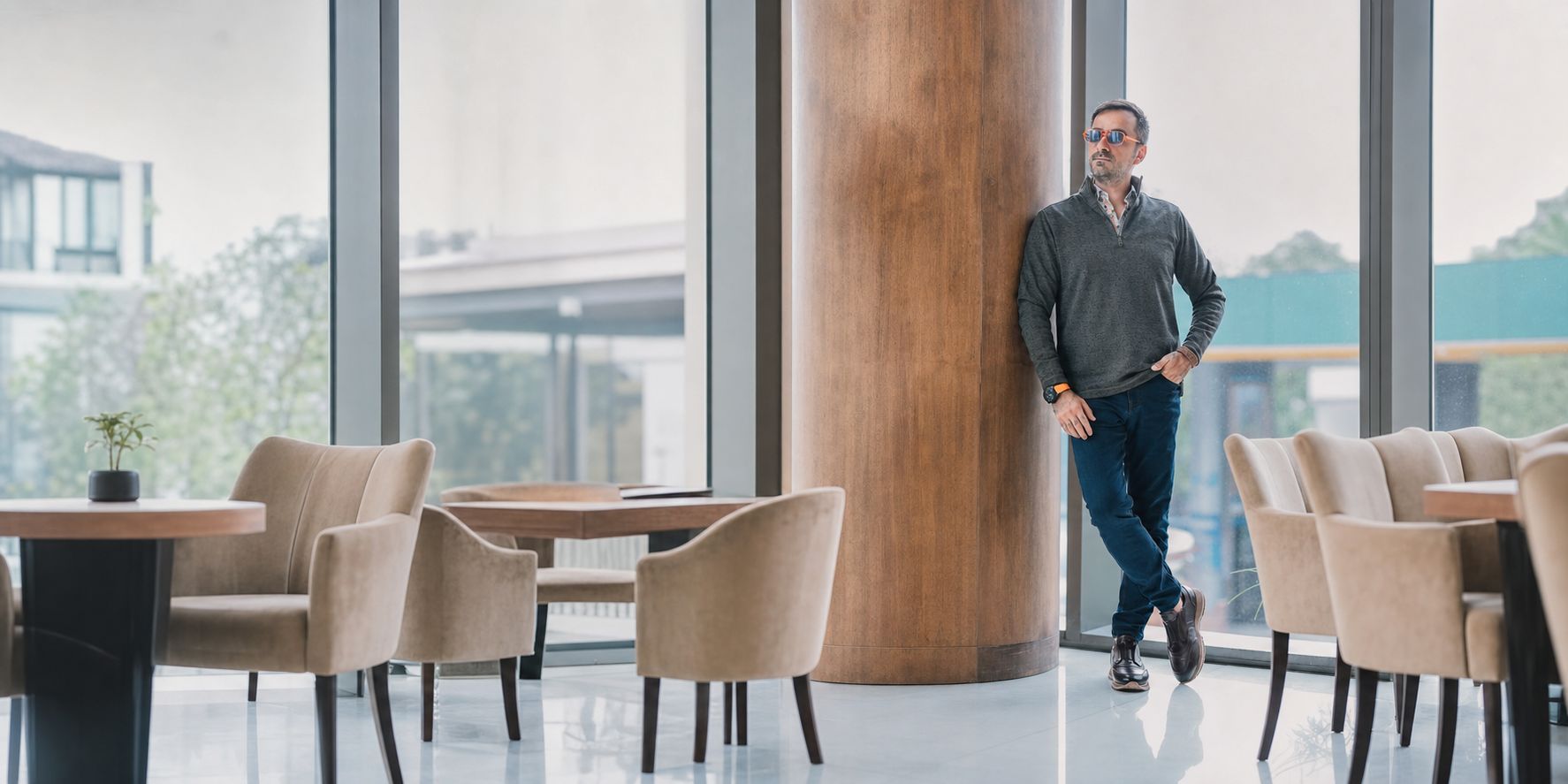 Marcello model wearing jeans and quarter zip pullover.