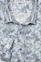 This Marcello shirt features a blend of soft cotton and linen, with a timeless blue check pattern and a striking abstract floral print.