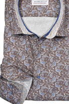 Boast a sleek, trendy look with this beautiful mocha to bronzed shirt, boasting warm tan and blue paisleys printed on a cotton-blend fabric. Pants in tan or brown hues make a splendid pairing with this timeless design, highlighted by custom neck and cuff trim, royal neck piping and a classic fit. by Marcello