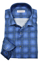 This Marcello Lakeside Plaid Roll Collar features a unique one piece roll collar that adds a touch of style to any outfit, whether it's worn alone or under a sport coat. The soft blue plaid pattern with a subtle medallion design is perfect for both dressy and casual occasions.