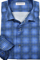 This Marcello Lakeside Plaid Roll Collar features a unique one piece roll collar that adds a touch of style to any outfit, whether it's worn alone or under a sport coat. The soft blue plaid pattern with a subtle medallion design is perfect for both dressy and casual occasions.