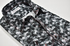 Elevate your wardrobe with the Marcello Midnight Granite Sport Shirt. Crafted from soft cotton, this shirt features a unique abstract granite pattern that pairs perfectly with black, charcoal, or white bottoms.