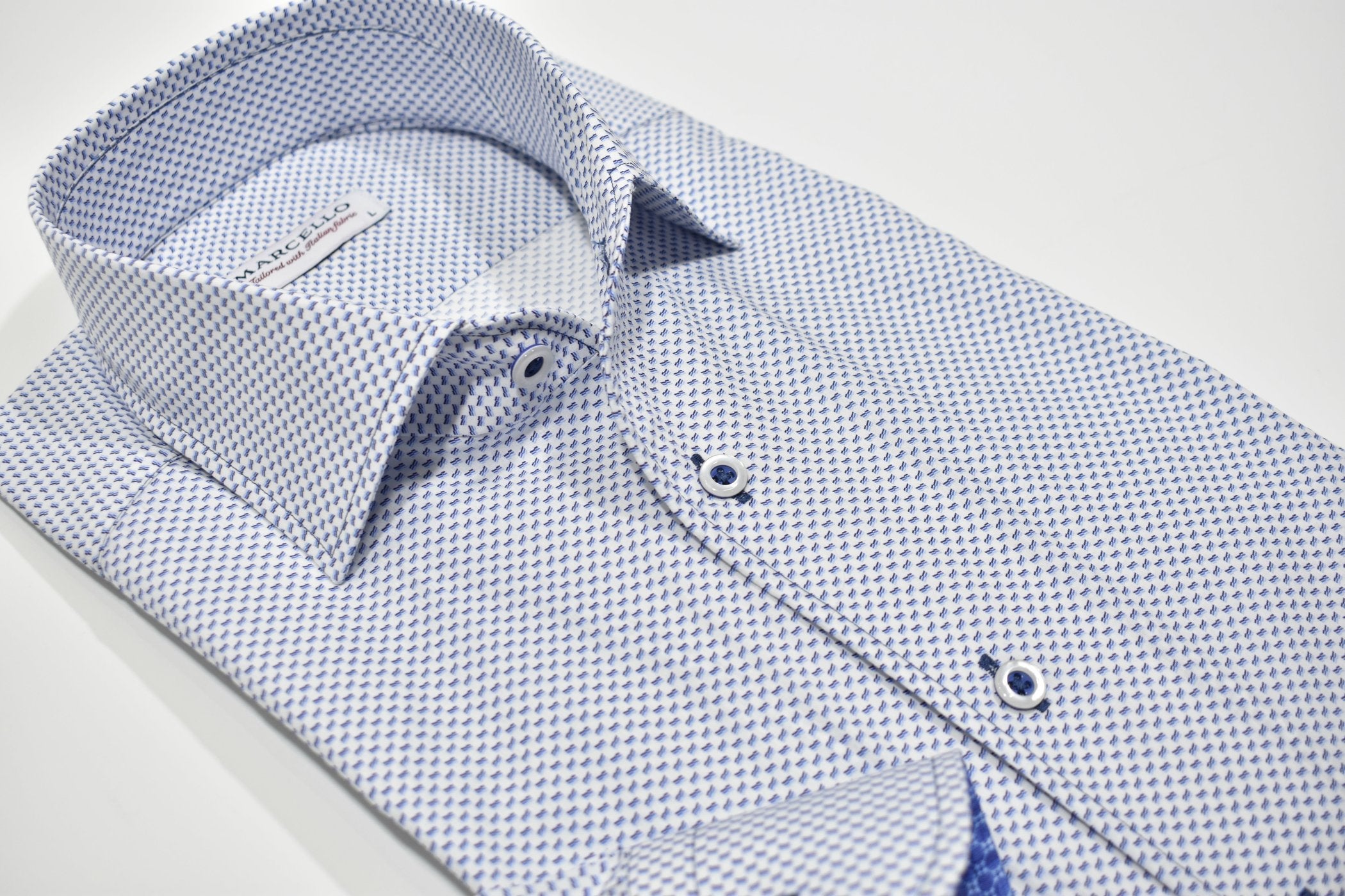Rich. Elegant. A Must Have. Featuring a Marcello exclusive one piece roll collar, this medium blue and navy neat patterned shirt is classic in nature, but exudes a fashion sense. Fantastic worn alone with pant or jeans or excellent under a sport coat.