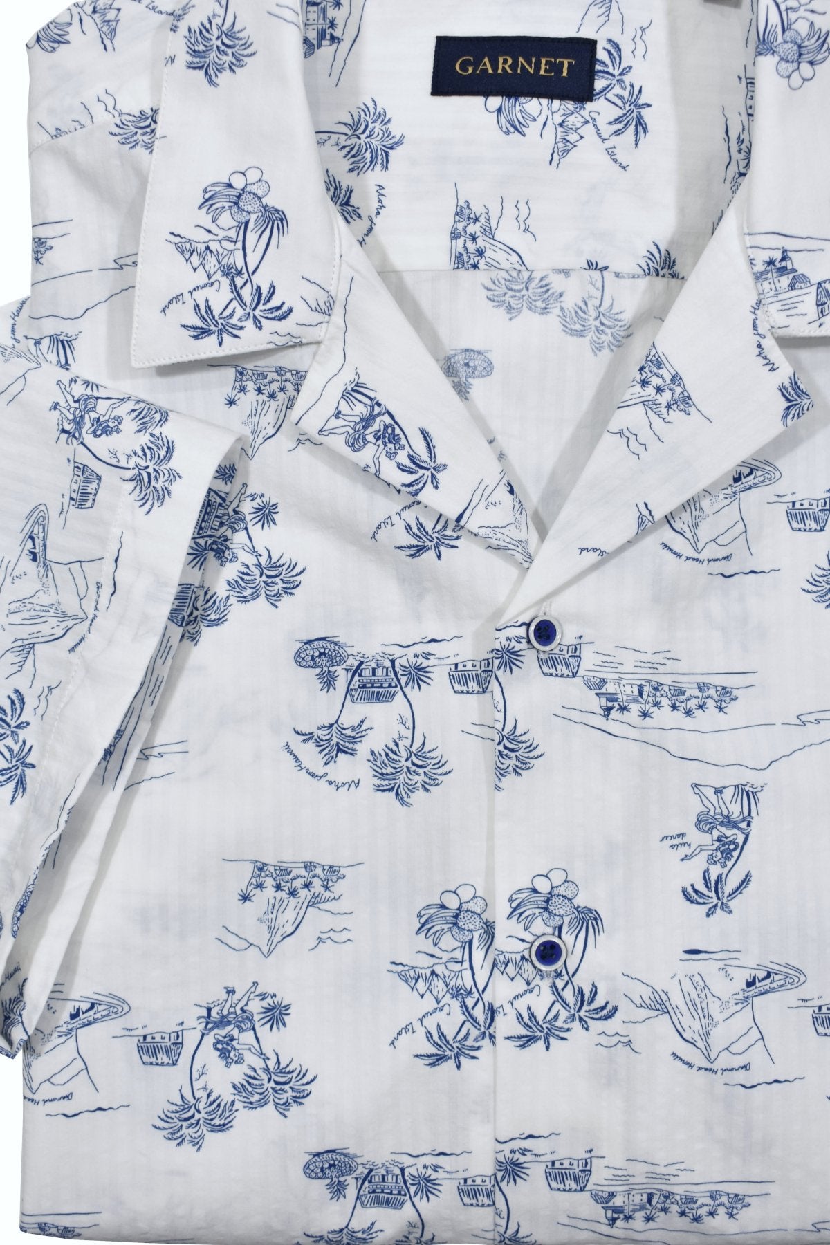 Relax and dream away in a cool casual lifestyle. Made with soft white cotton seersucker fabric and a matching island motif print in warm blue, this shirt brings a cool and comfortable look. Its pajama top collar adds to the relaxed fit, making it perfect for your island getaway.