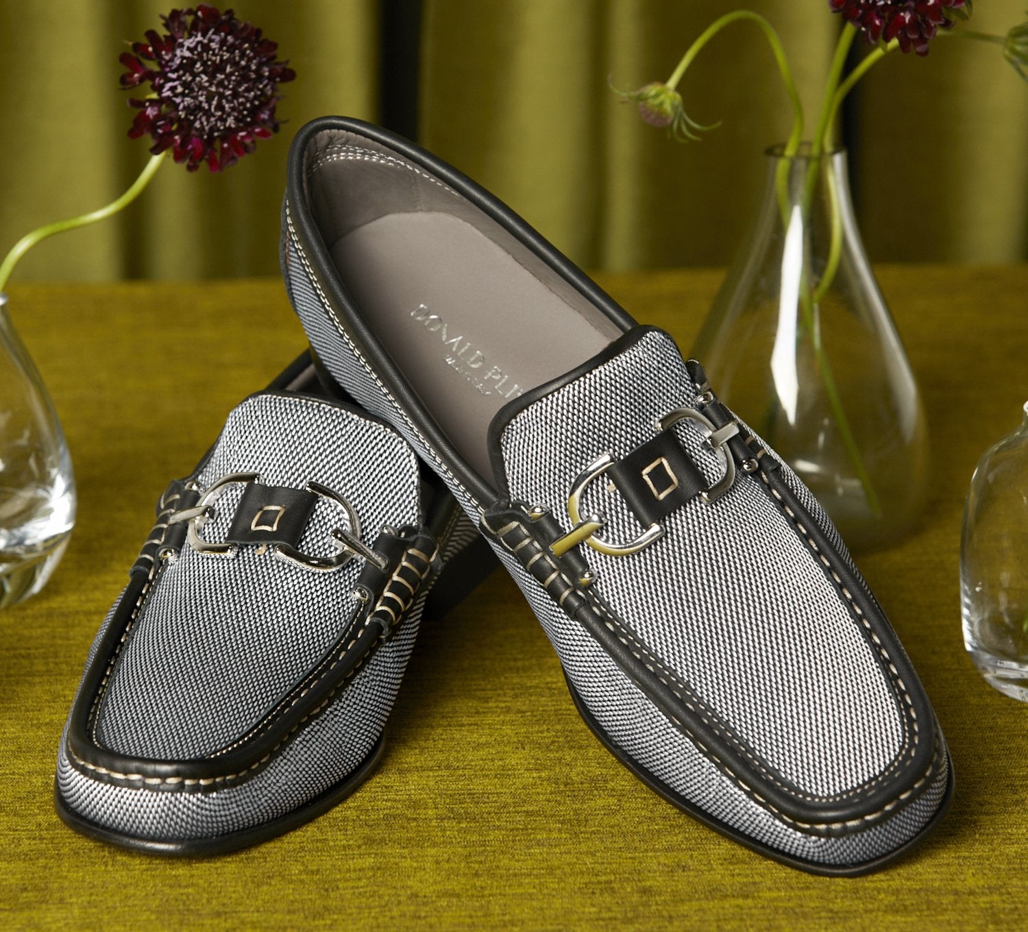 Make a statement with Silver Italian Dacio. This classic Donald Pliner shoe oozes style and fashion with its textured canvas outer mixing dark charcoal and silver, leather trim, signature Pliner hardware, and a leather sole. Its light grey color with dark charcoal trim will lend a sophisticated touch to any outfit.