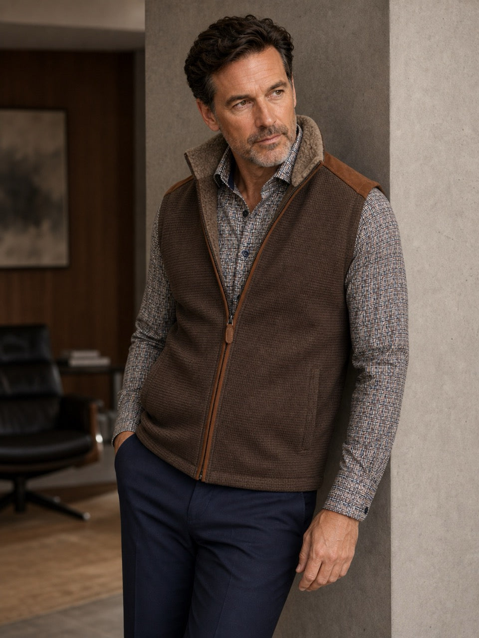 Perfect for the season, this vest features a faux leather outer with a fine subtle box print pattern and soft fur lining to add warmth and style. The vest features a stand up collar, two way zipper and ultra suede trim on the shoulders and along the zipper. Classic fit.