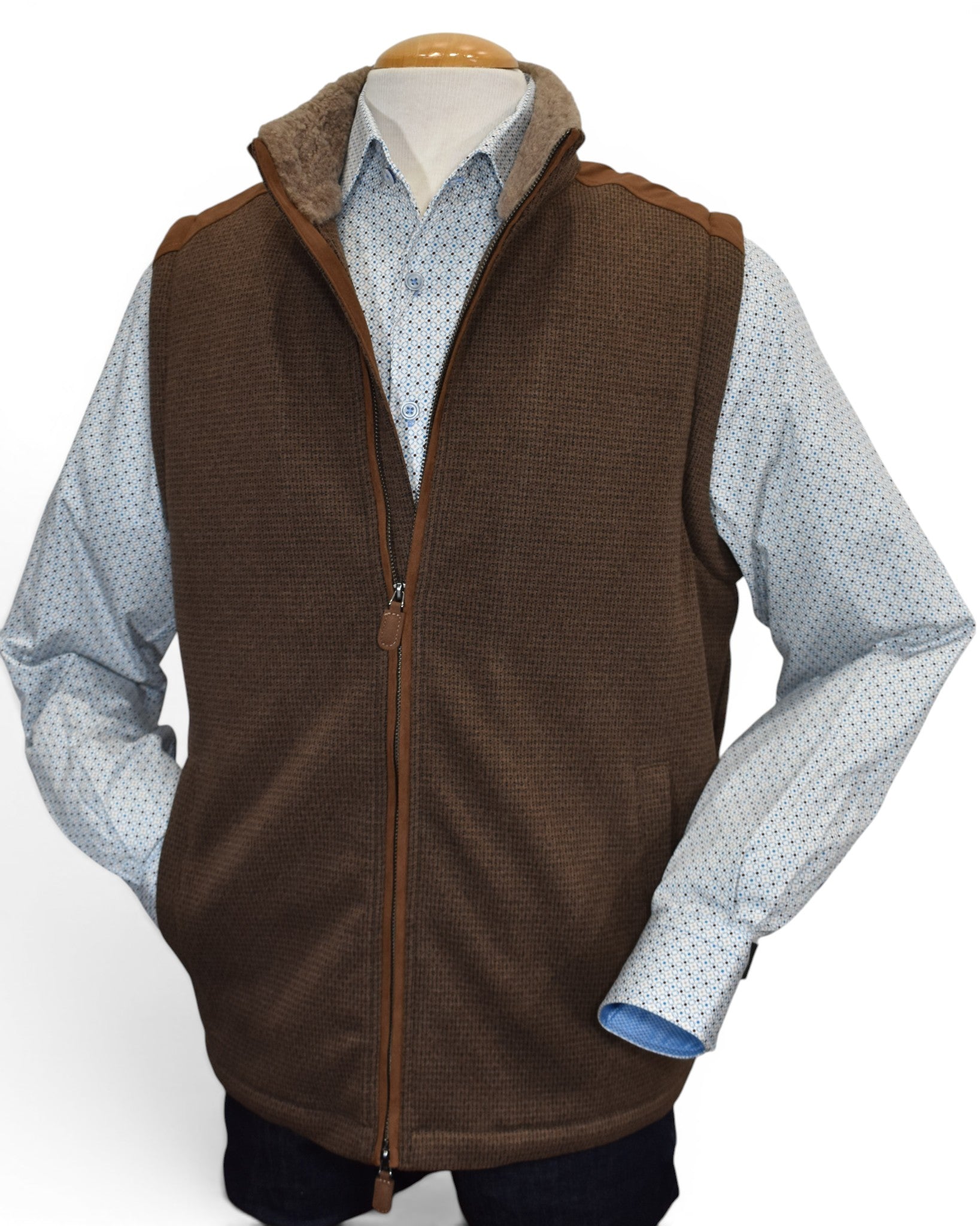 Perfect for the season, this vest features a faux leather outer with a fine subtle box print pattern and soft fur lining to add warmth and style. The vest features a stand up collar, two way zipper and ultra suede trim on the shoulders and along the zipper. Classic fit.
