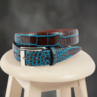 Crafted with impeccable attention to detail, the ZT52905 Italian Embossed Croc Cognac belt exudes sophistication and elegance. Crafted with soft Italian calf leather in a rich chocolate hue, it has been stained with a teal technique for an unforgettable statement tone. Statement silver buckle and a 35mm or 1 7/16" width is the final nuance of this timeless accessory, perfect with any cool jeans.