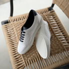 Step out in style with the S132 White Trend sneaker, crafted with soft leather and a navy accent for a cool, classic look. Contoured foot bed and firm sole provide all-day comfort and stability, perfect for work or leisure. Hand made in Spain, these stylish sneakers are an essential addition to your wardrobe.