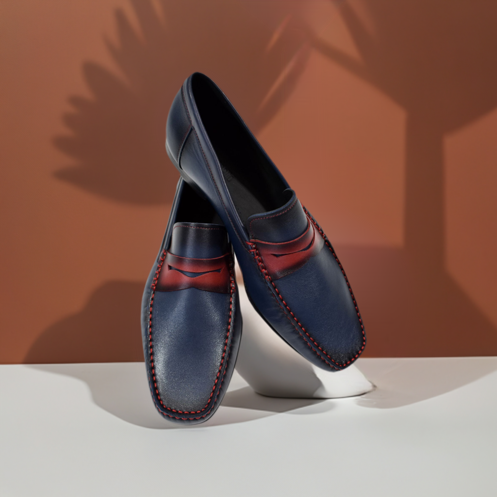 The S127 Indigo Dress Sport Shoe brings a touch of modern sophistication to any look. The burnished leather shoe in indigo with red accents is perfect for formal and casual wear, providing a timeless style with a hint of flair. Handcrafted in Spain and designed with a classic fit, this shoe is sure to become a wardrobe staple.