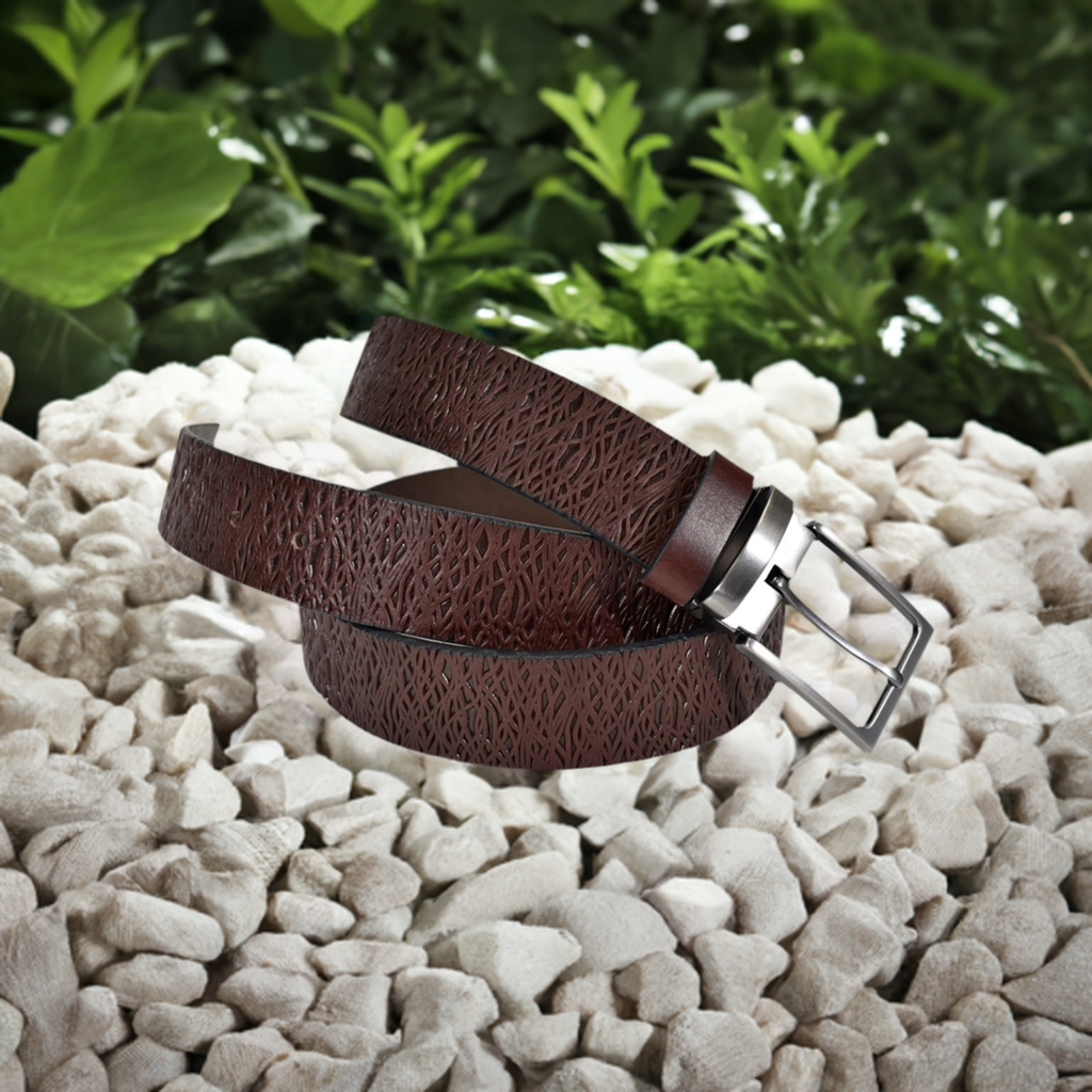 Crafted from Marcello leather, this belt's abstract weave-like stamps make a luxe yet subtle statement! Upon close inspection you will see the intricate details of a leather stamped weave. With a brushed nickel buckle, it's available in sizes 32 - 40 and the shades of Brown or Indigo.