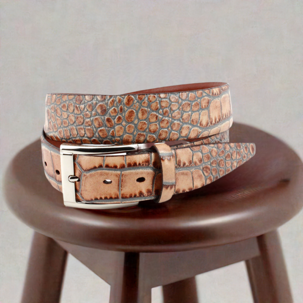 Crafted with impeccable attention to detail, the ZT52904 Italian Embossed Croc Cognac belt exudes sophistication and elegance. Crafted with soft Italian calf leather in a rich tan hue, it has been stained with a gray technique for an unforgettable statement tone. Statement silver buckle and a 35mm or 1 7/16" width is the final nuance of this timeless accessory, perfect with any cool jeans.