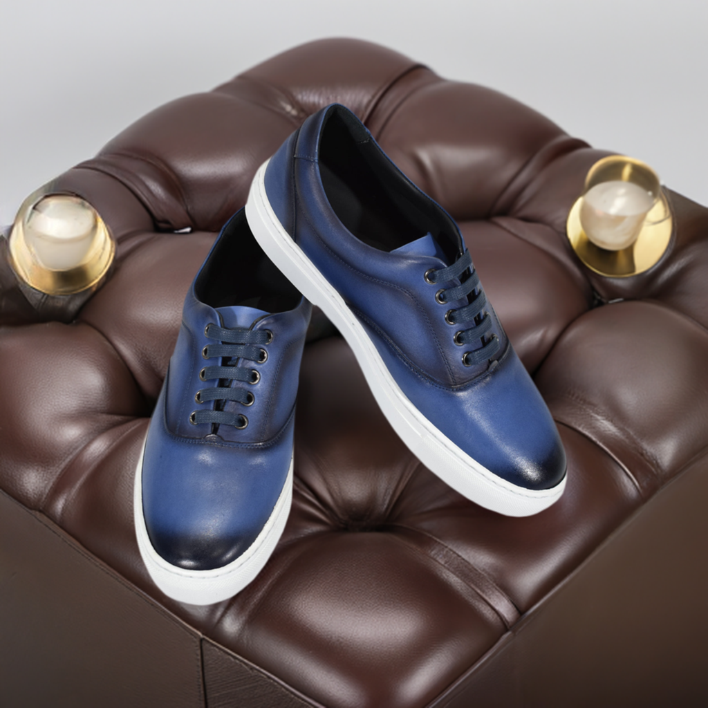 Look sharp and stylish with S130 Navy Burnished Sneaker. This classic men's sneaker features a fashionable leather upper and medium sole height for a sleek, casual look. Soft cushion insole provides superior comfort while the simple clean design sets a modern image. Perfect for everyday wear! Expertly crafted in Spain. Get the perfect fit with Classic fit.  Designed and manufactured in Spain.