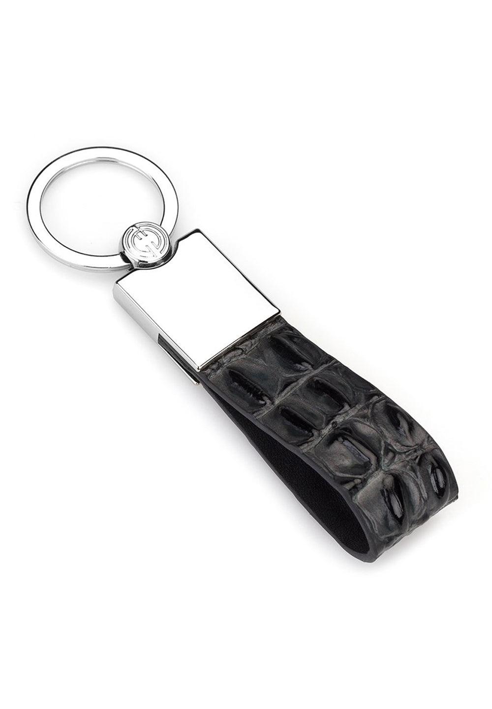 Great gift giving idea for yourself or that individual that has everything.  Leather stamped and shaded croc pattern. Contemporary chrome key attachment. Approximately 3" by 1/2". By Marcello Sport