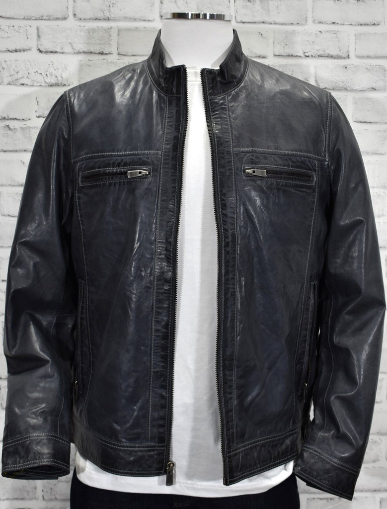 Soft washed leather in a rich charcoal coloration with accent silver stitching is the perfect coat for dress or casual occasions. Sport stand up collar.  Classic side pockets and internal chest pockets with an open bottom and open adjustable cuff.   Light weight.  Classic fit. Charcoal leather by Marcello Sport